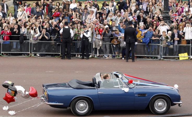 Prince William and his wife Catherine, Duchess of Cambridge drive from Buckingham Palace in an Aston Martin DB6 Mark 2.