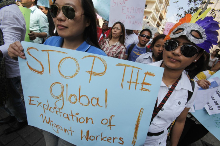 Migrant workers hold placards during a demonstration to support the rights of migrant domestic workers on International Workers' Day or May Day, in Beirut