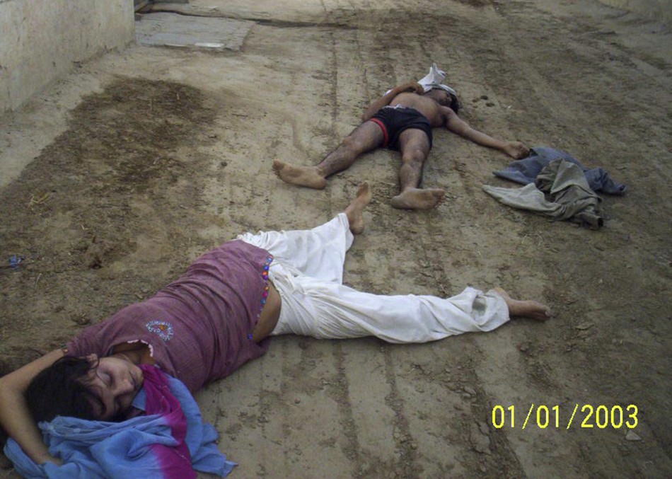 The bodies of Sunita Devi (L), 21, and her partner Jasbir Singh, 22, lie on the ground after they were killed by villagers in an &quot;honour killing&quot; in Ballah village in the northern Indian state of Haryana