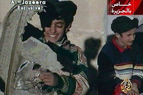 Picture taken from undated Al Jazeera television footage purportedly shows Hamza bin Osama bin Laden (L), one of the sons of Saudi-born dissident Osama bin Laden, displaying what the Taliban say is wreckage from a U.S. helicopter near Ghazni. Child at rig