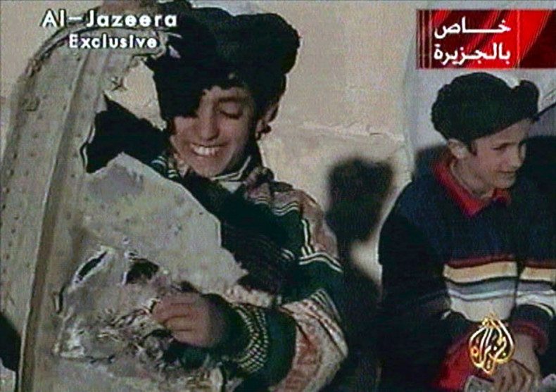 Picture taken from undated Al Jazeera television footage purportedly shows Hamza bin Osama bin Laden (L), one of the sons of Saudi-born dissident Osama bin Laden, displaying what the Taliban say is wreckage from a U.S. helicopter near Ghazni. Child at rig