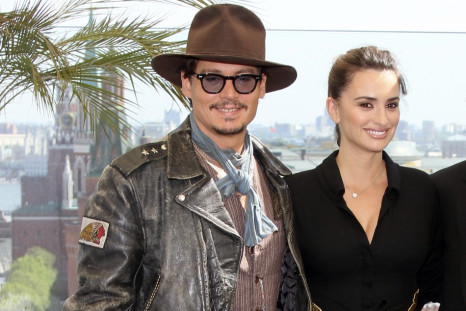 Actors Depp and Cruz pose for photographers in front of the Kremlin during a news conference in Moscow