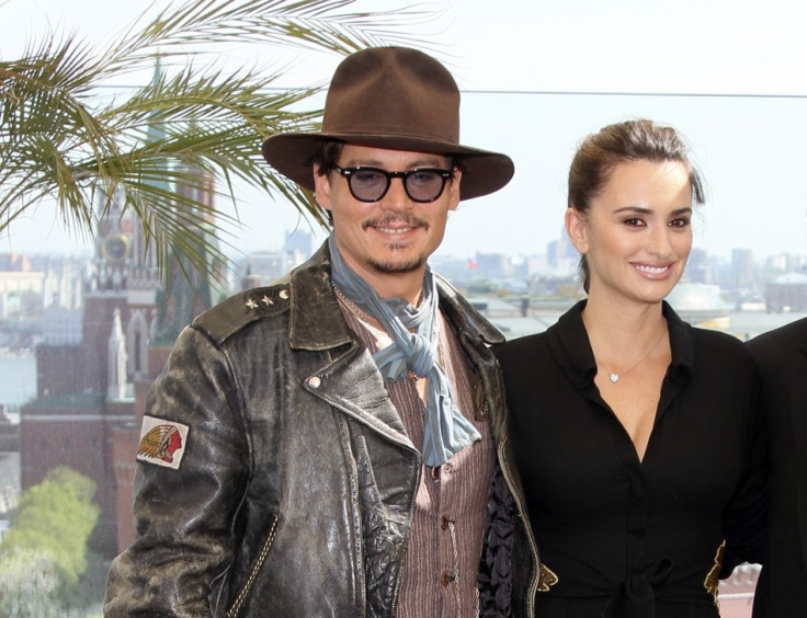 Actors Depp and Cruz pose for photographers in front of the Kremlin during a news conference in Moscow