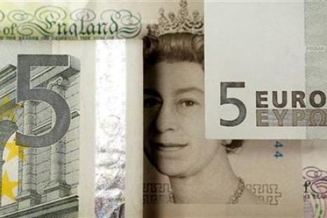A generic image shows the face of Queen Elizabeth seen on a five pound note alongside euro currency in London