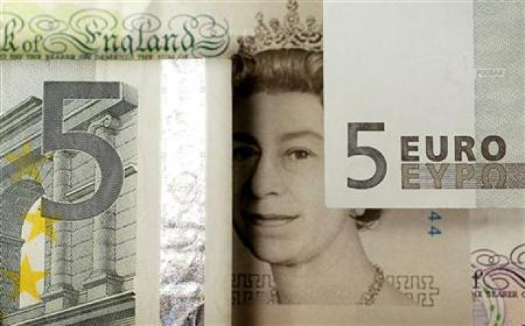 A generic image shows the face of Queen Elizabeth seen on a five pound note alongside euro currency in London