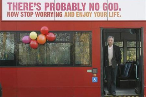 British author Richard Dawkins stands on a bus at the launch of an atheist advertising campaign in London