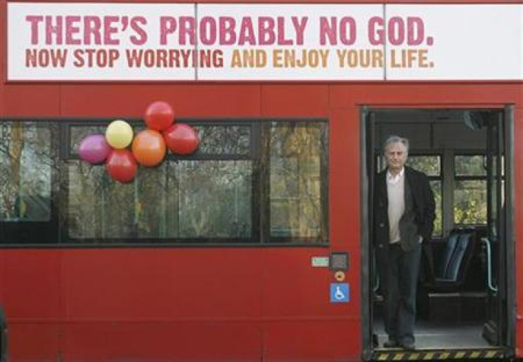 British author Richard Dawkins stands on a bus at the launch of an atheist advertising campaign in London