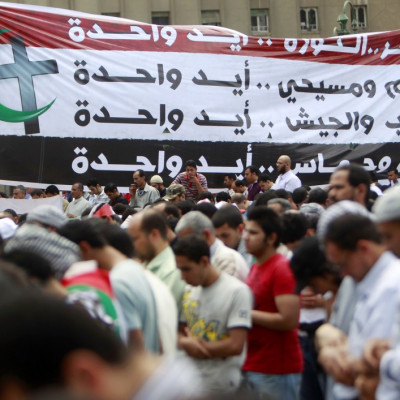 People take part in Friday prayers during a protest at Tahrir Square in Cairo