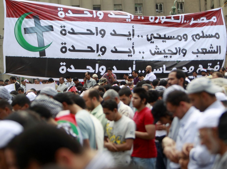 People take part in Friday prayers during a protest at Tahrir Square in Cairo