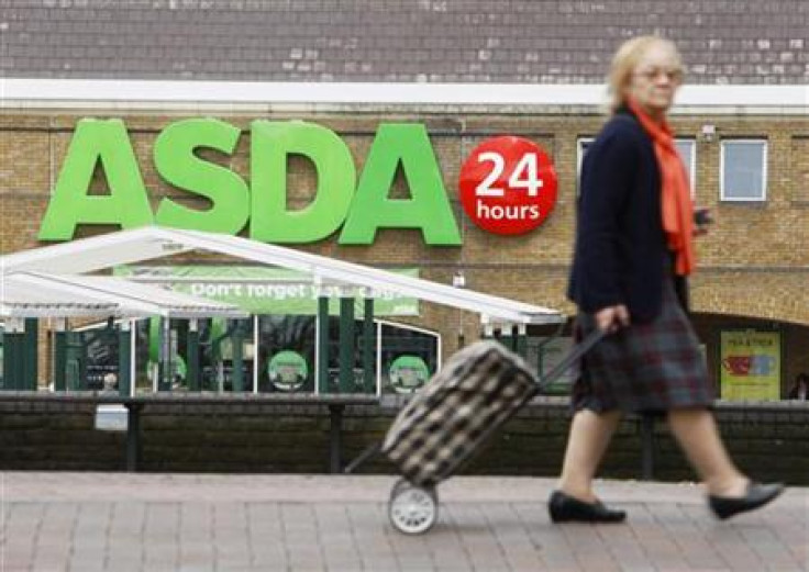 A shopper walks past an Asda superstore in south London